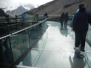 One can see the canyon bottom through the plexiglass floor of the Skywalk.